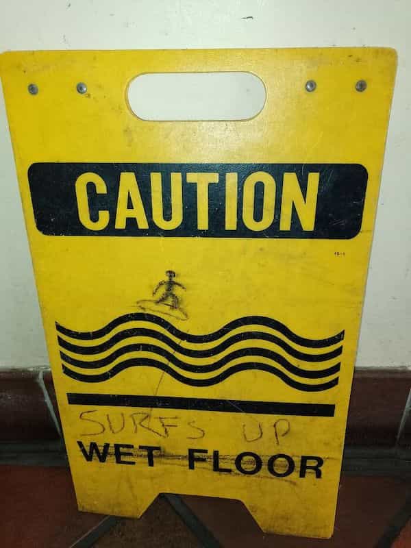 funny graffiti CAUTION SURFS UP WET FLOOR
