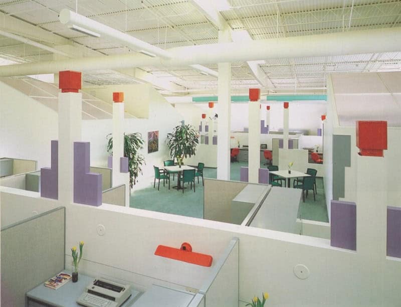 Open plan retro office with pastel cubicles and colorful geometric decor