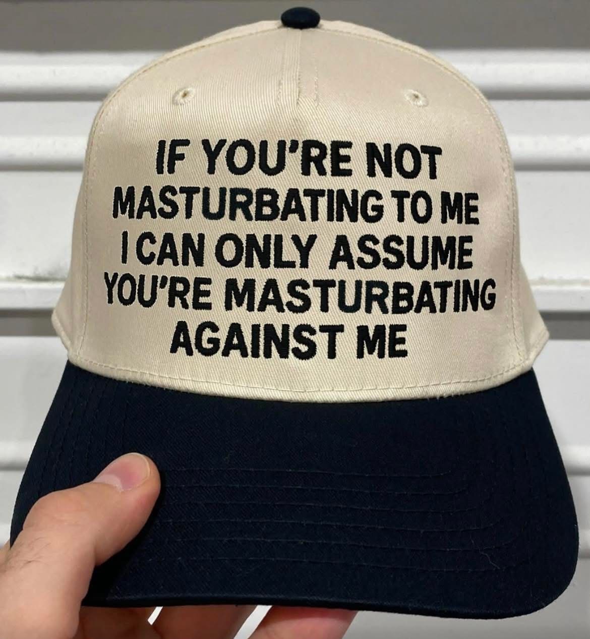 A funny pic of a baseball cap with a very bold and confrontational embroidered message.