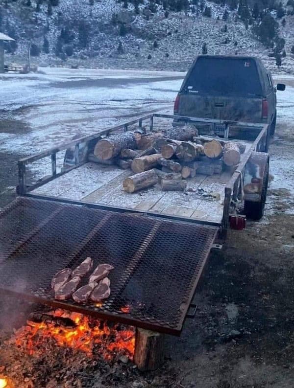A piece of redneck engineering where a massive trailer ramp is used as a giant barbecue grill.