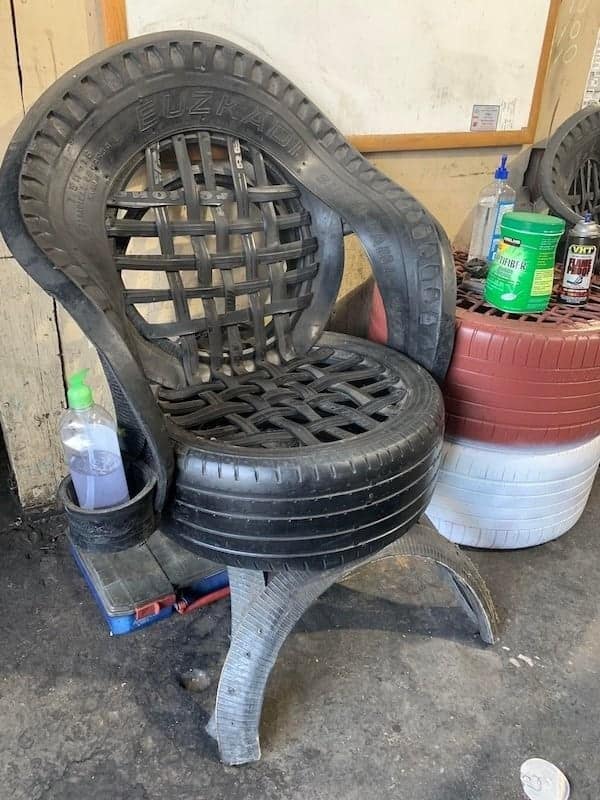 An impressive piece of redneck engineering showing a chair expertly crafted entirely from old car tires.