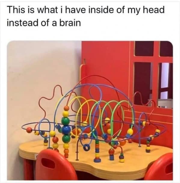 Colorful bead maze toy on a wooden table in a children's play area
