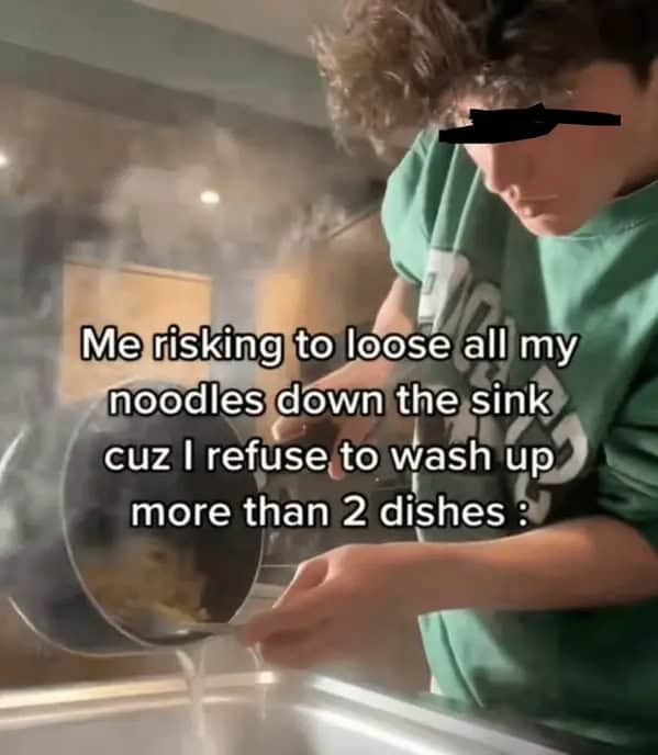 Person straining pasta into the sink from a steaming pot with caption about risking all the noodles to avoid washing extra dishes.
