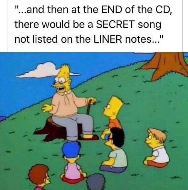 Grandpa tells a story to kids on a hill, caption about secret songs hidden at the end of CDs and not listed in liner notes.