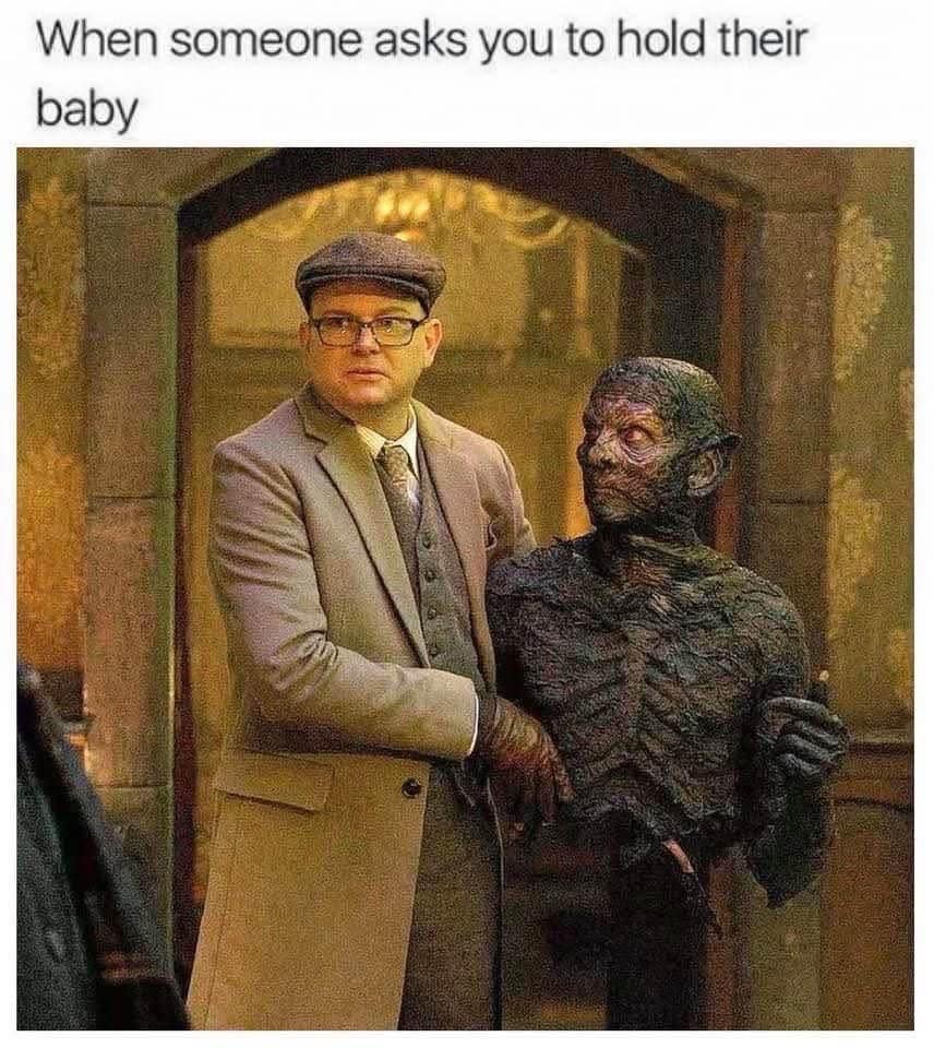 A reaction meme about holding a baby, using an image from What We Do in the Shadows.