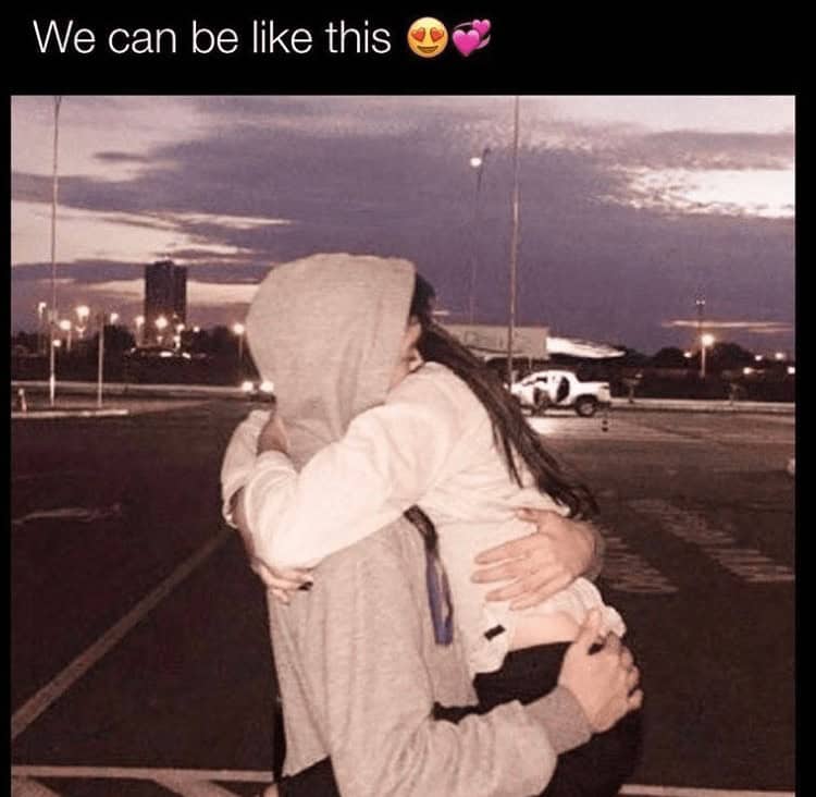A cute picture of a young couple hugging in a parking lot at night, presented as a perfect relationship goal.