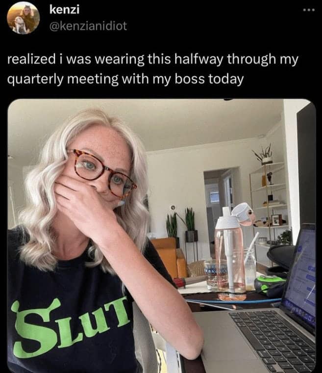 Woman covers her mouth after noticing her T-shirt with a bold, inappropriate word during a video meeting at home.