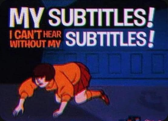 Classic meme parodying Scooby-Doo with Velma needing subtitles instead of glasses.