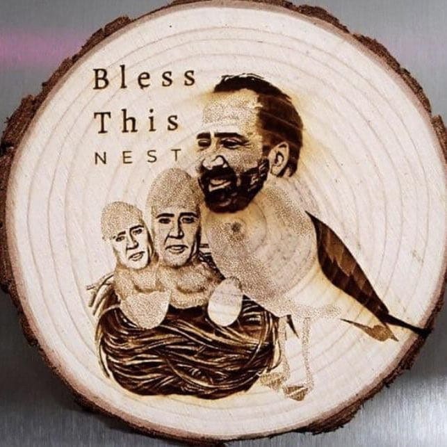 Wood burning art of Nicolas Cage faces on birds in a nest titled Bless This Nest.