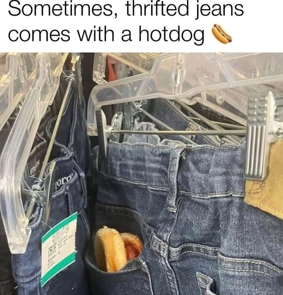 Pair of blue jeans on hanger with a hotdog inside the back pocket.