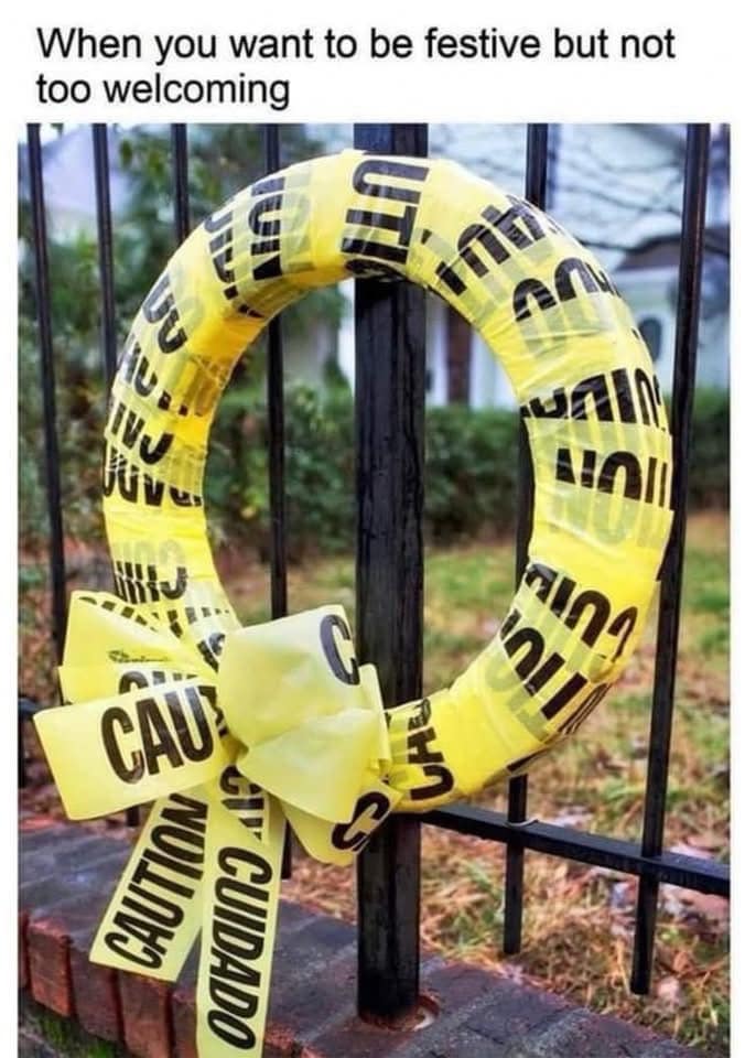 A funny meme showing a holiday wreath wrapped in yellow caution tape