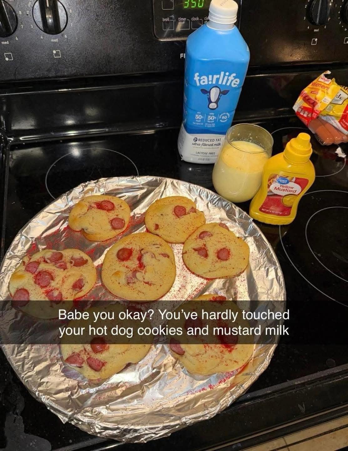 A cursed food image showing hot dog cookies and a glass of mustard milk.