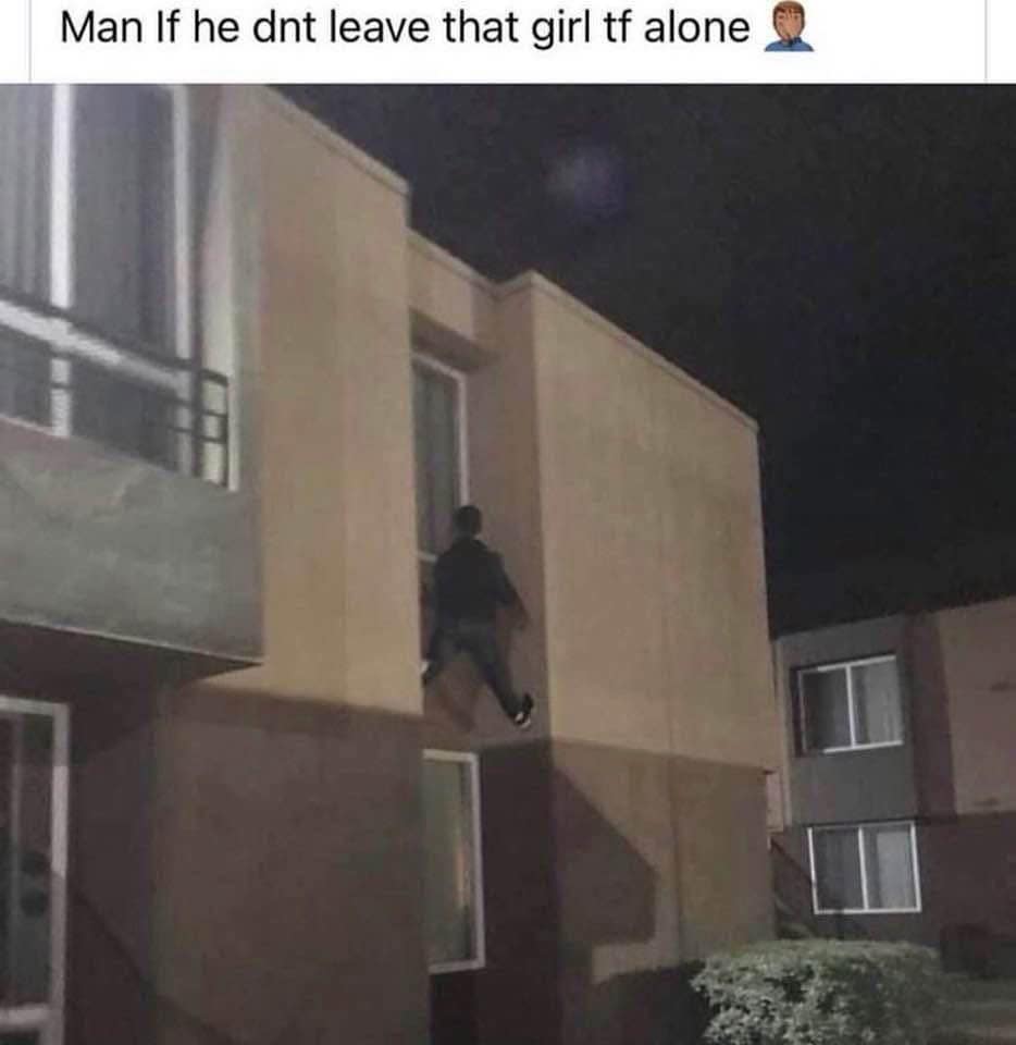 A funny meme photo of a man dangerously climbing the side of a building to get into a window.