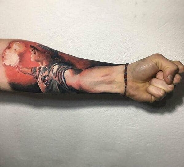 Soccer fan holding flare interactive hand tattoo on forearm questionable tattoos.