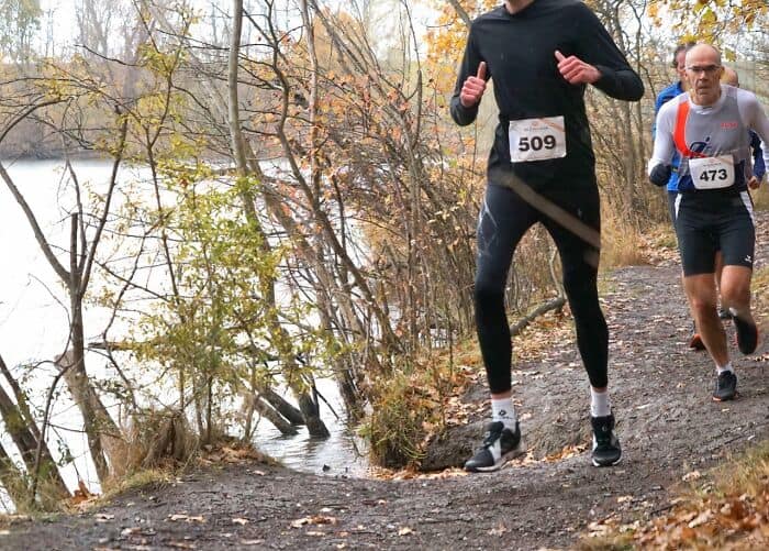 A tall people problems race photo where the runner's head is cropped out of the frame.