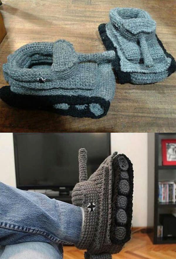 A pair of grey creative knitting project slippers shaped like miniature military tanks.