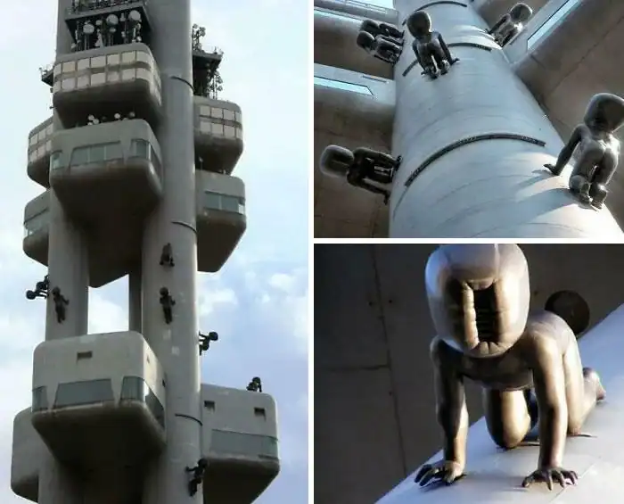 Zizkov Television Tower in Prague featuring giant crawling baby sculptures on its industrial exterior pillars.