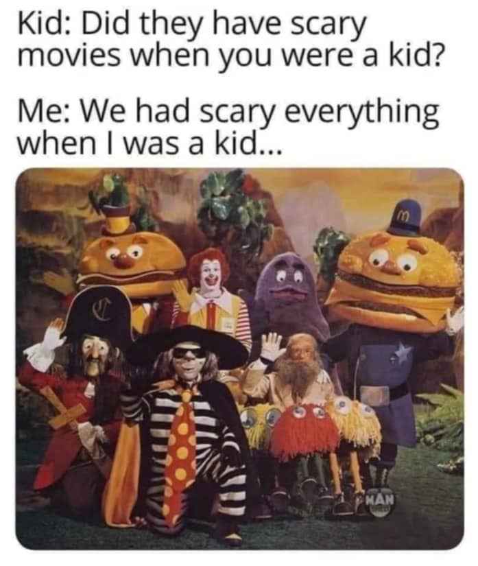 A vintage photo of early McDonald's characters like Grimace and the Hamburglar looking creepy in a group.
