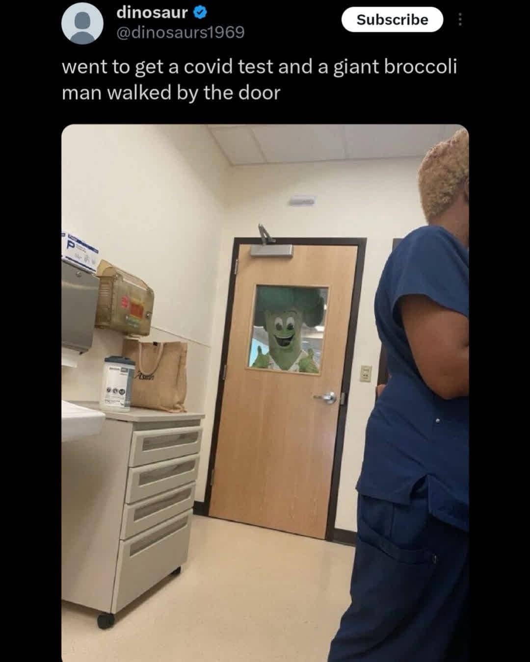 Funny social media post showing a giant broccoli mascot walking past a COVID testing room.