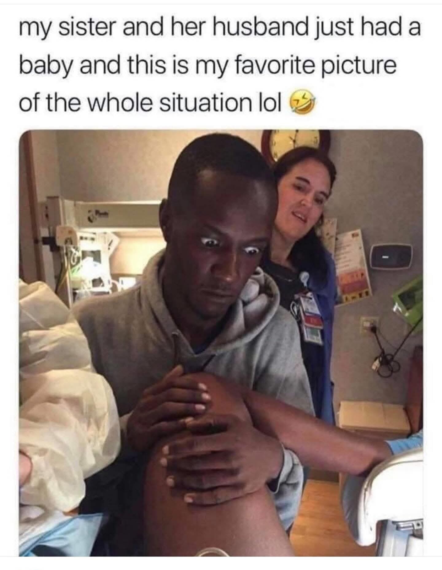 A hilarious meme photo of a man looking absolutely terrified while holding a woman's leg during childbirth.