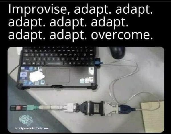A geeky meme showing a long chain of VGA and DVI adapters connecting a laptop to a monitor with the caption "improvise, adapt, overcome."
