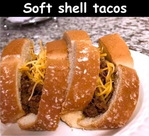 chaotic food classic meme showing the most literal interpretation of "soft shell tacos" possible, featuring basic ground beef and shredded cheddar cheese stuffed into folded slices of plain white bread.