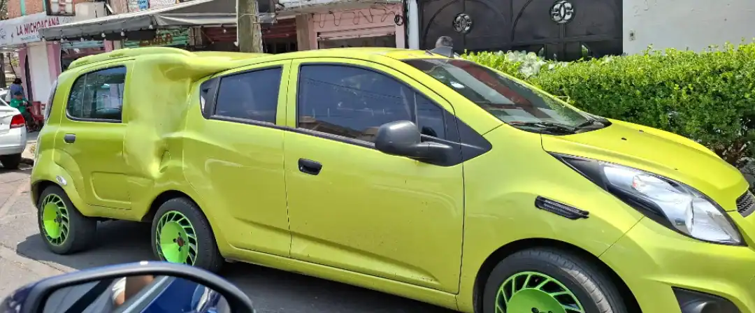 Bright lime green sedan extended with an extra middle section and a matching custom rear body.