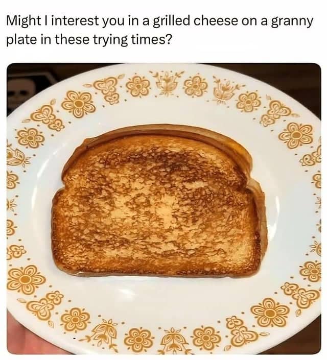 Perfectly toasted grilled cheese sandwich served on a classic floral pattern Corelle vintage dinner plate.