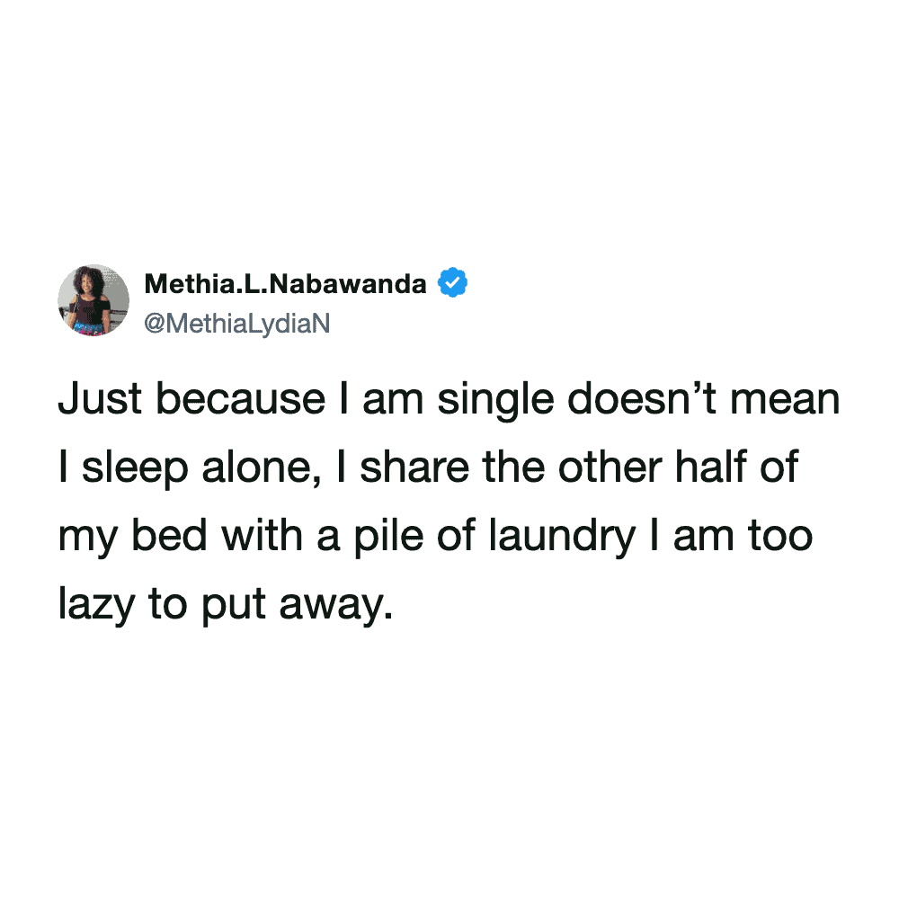 hilarious laundry meme about romance, where a single user jokes that they don't sleep alone because they share the other half of their bed with a massive pile of unbothered clean clothes in a staple funny tweet about laundry.