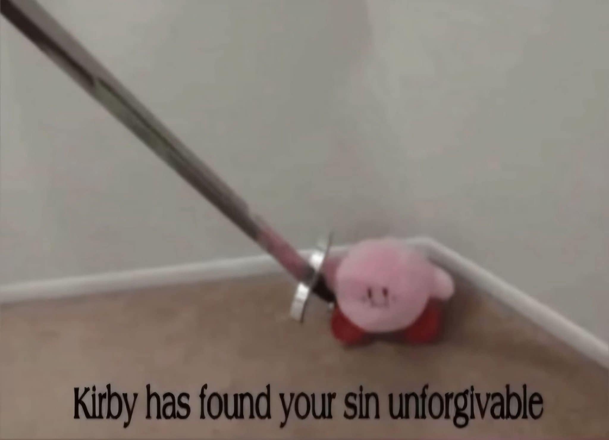 A classic and threatening meme dump visual featuring a small, round pink Kirby plush tucked into a corner on a carpeted floor. The plush is holding a large, sharp metal sword, accompanied by the text: "Kirby has found your sin unforgivable."