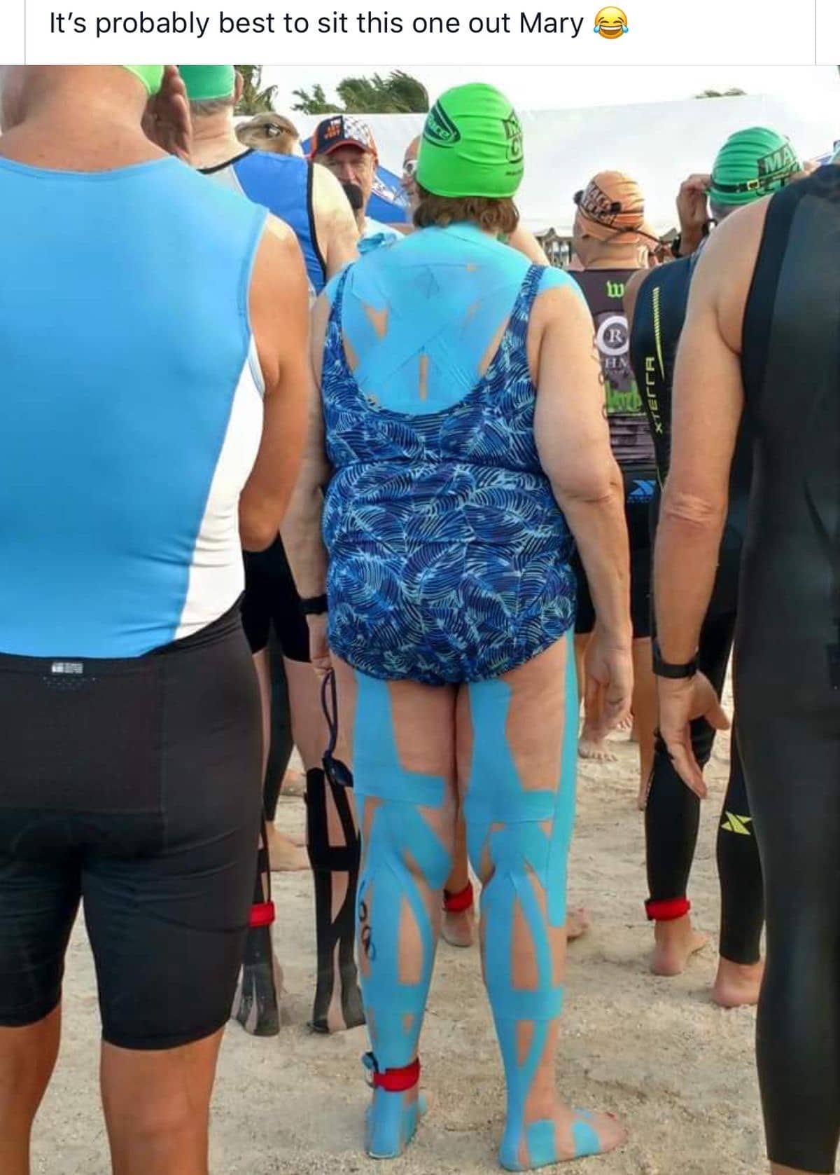 Woman at a triathlon covered in excessive blue athletic tape with a funny caption about sitting out.