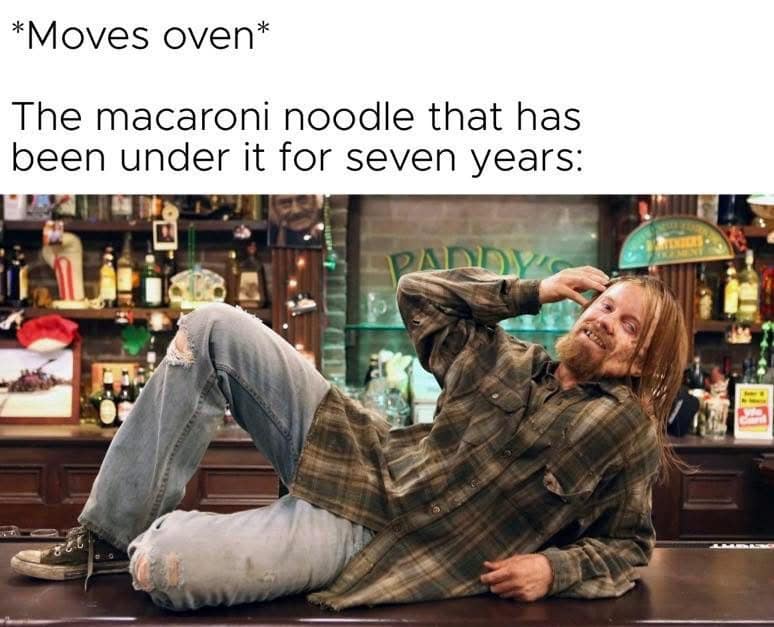 A hilarious meme featuring the character Rickety Cricket from It’s Always Sunny in Philadelphia lounging disheveled on a bar top. The caption reads: "*Moves oven* / The macaroni noodle that has been under it for seven years:".