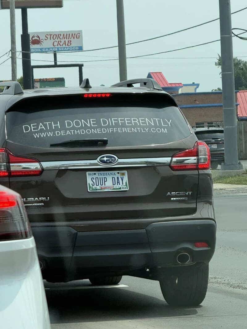 Subaru SUV with decal reading death done differently and vanity license plate reading soup day.