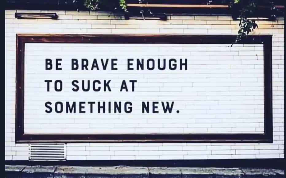 Outdoor marquee sign encouraging people to embrace failure when trying new motivational memes.