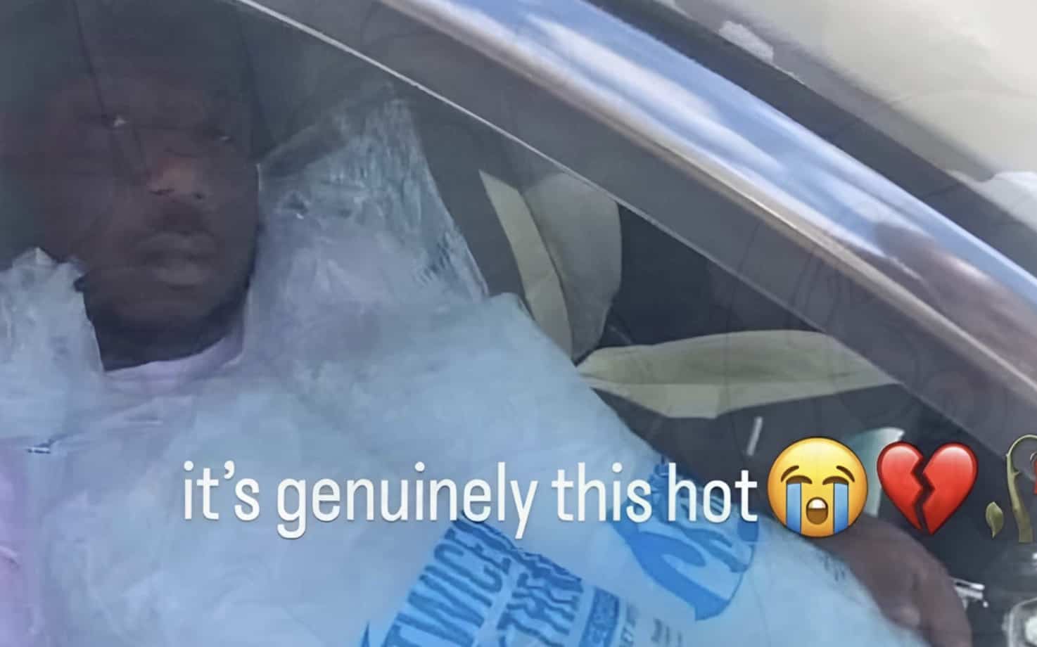 Funny heatwave meme showing a man sitting in a hot car covered with ice bags.