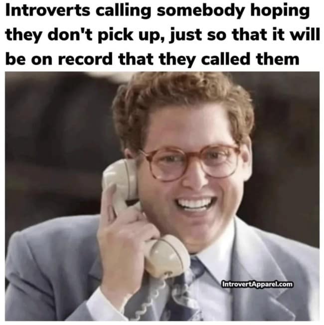 A classic film screenshot working as an introvert meme with Jonah Hill grinning into a phone, celebrating when a phone call goes straight to voicemail so social duty is fulfilled.