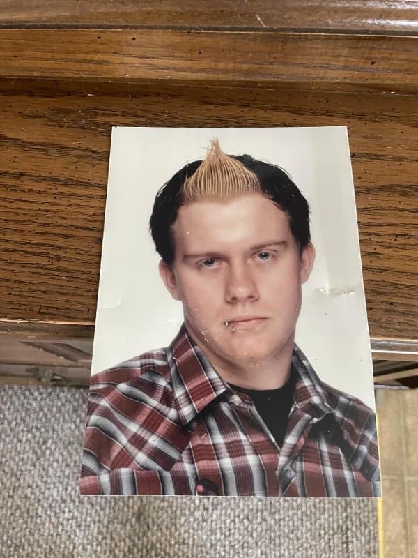 School photo of a teen with a bleached center spike and a lip piercing.