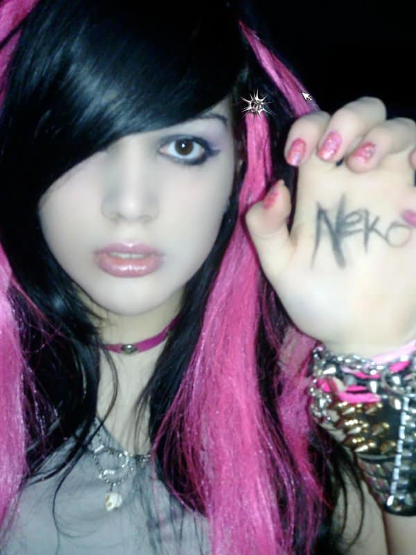 Blunder years selfie of a scene girl with pink streaks and a studded wrist cuff.