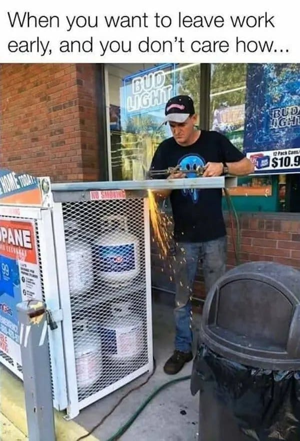 Man using a cutting torch on a propane tank cage outside a store, sparks flying.
