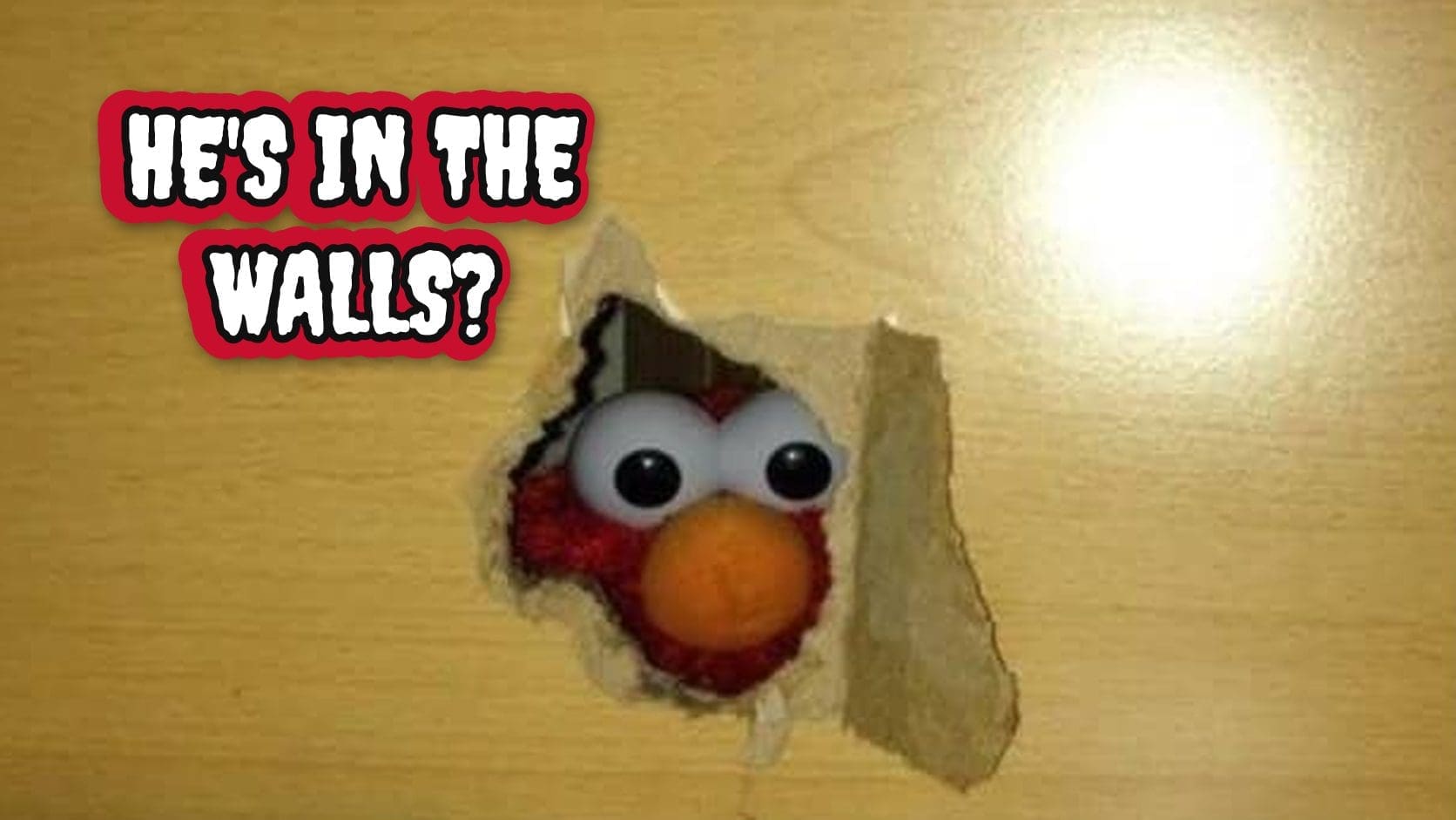 Elmo peeking through a hole torn in a wooden wall, the kind of creepy stare that fuels Elmo memes.