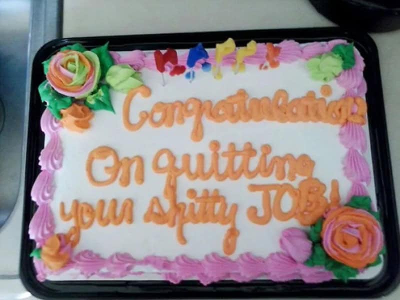 Floral sheet cake congratulating someone on quitting their bad job, with a mild curse word
