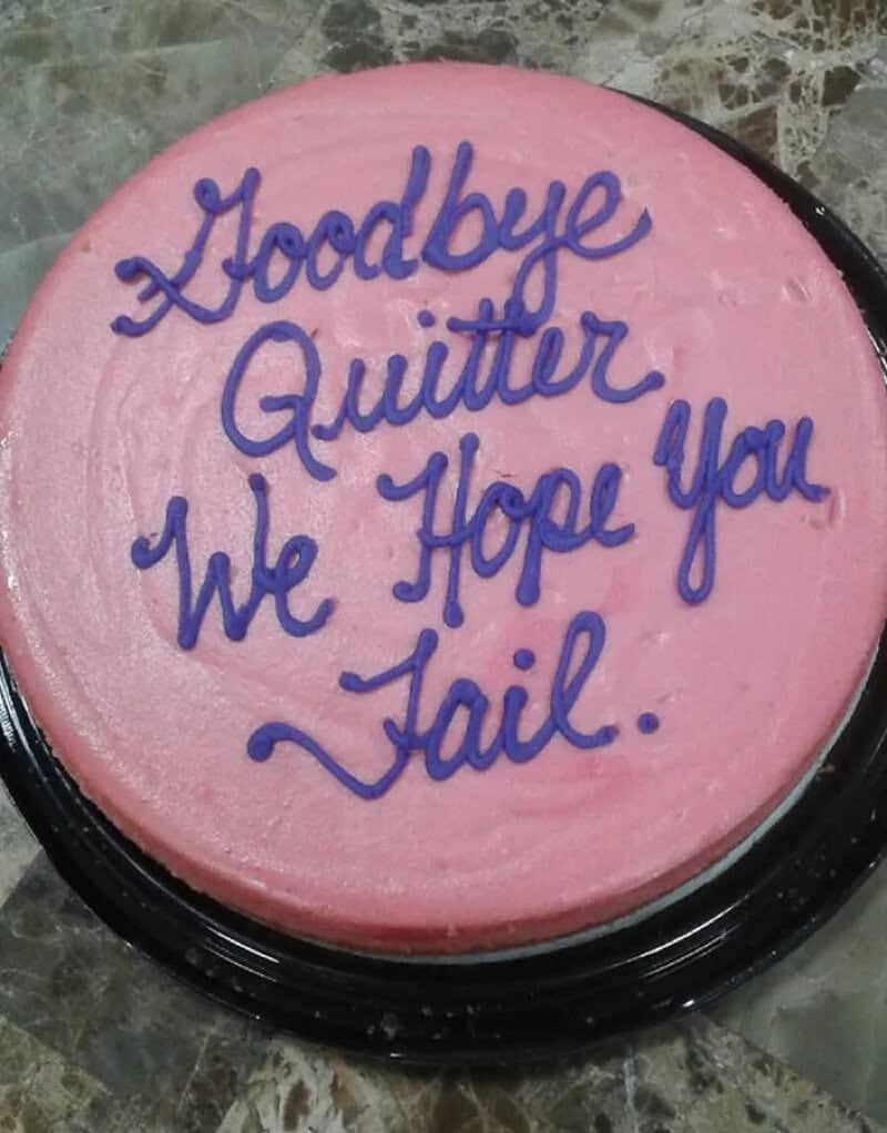 Pink round cake with purple script reading Goodbye Quitter, We Hope You Fail