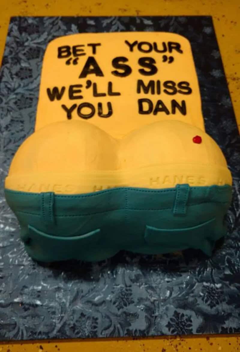 Novelty goodbye cake shaped like a backside in jeans saying they'll miss Dan