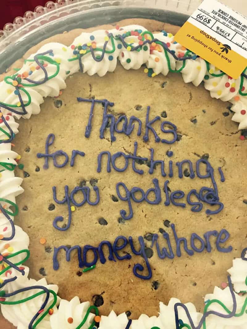 Cookie cake with rude purple icing thanking a departing coworker for nothing at all