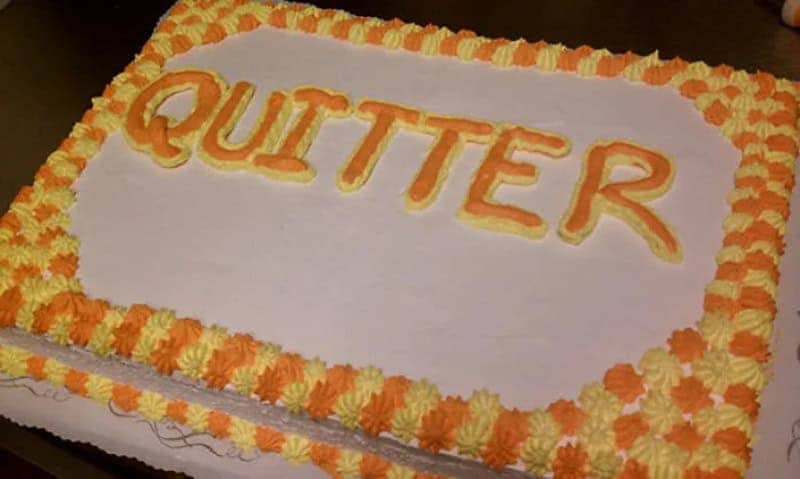 Orange and yellow sheet cake with QUITTER spelled out in bold frosting letters
