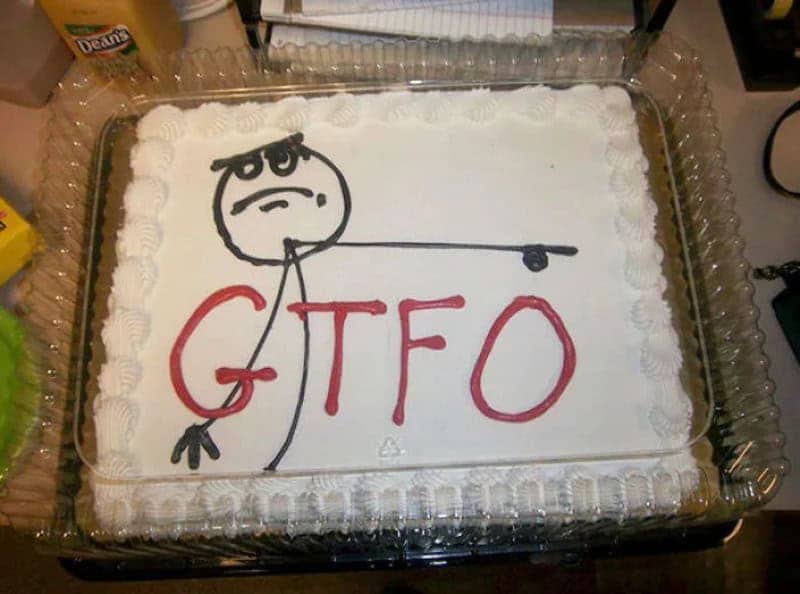 White sheet cake with a stick figure pointing to the exit above a rude acronym