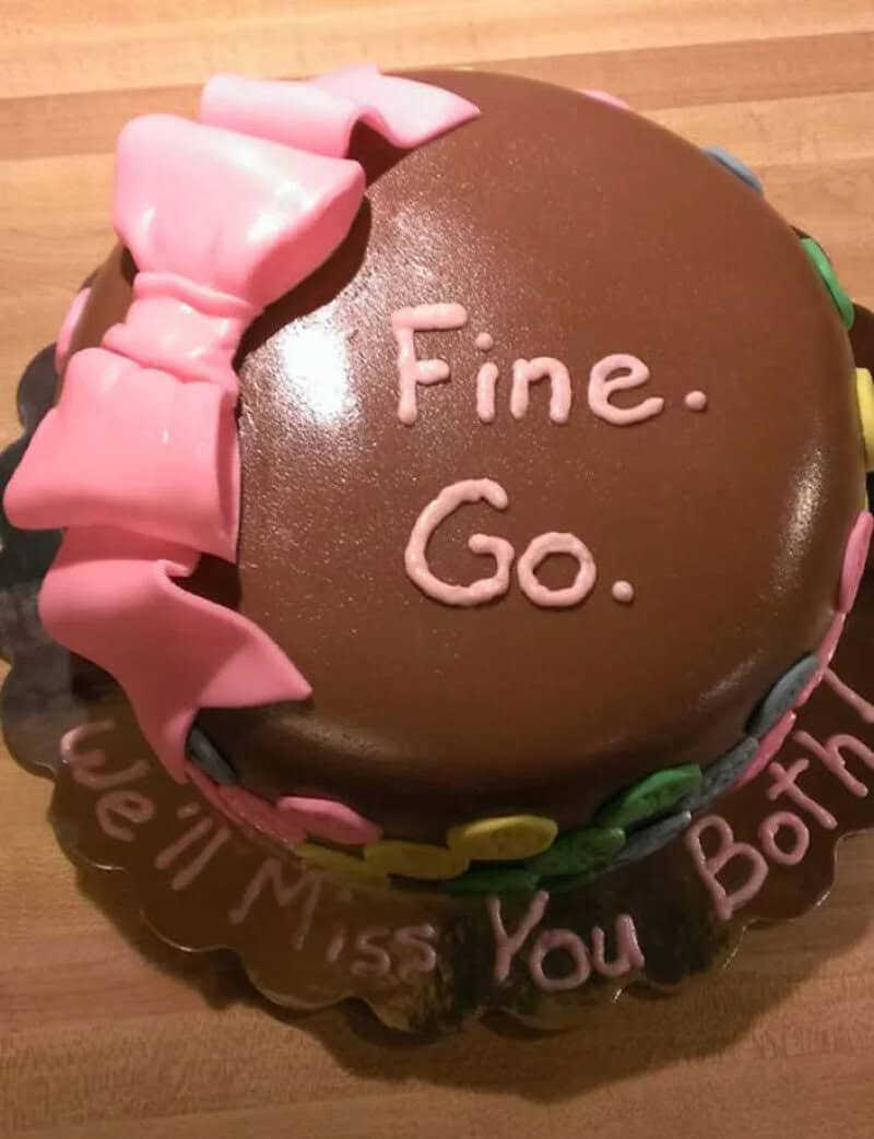 Round chocolate goodbye cake with a pink bow reading Fine. Go. We'll miss you both