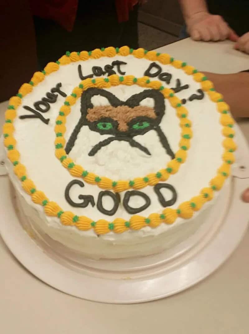 Round goodbye cake with a piped grumpy cat face saying your last day, good