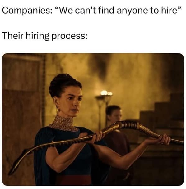 The Odyssey screenshot of Anne Hathaway in an ornate blue dress holding a massive ancient bow, labeled as absurd corporate hiring expectations in a funny meme.