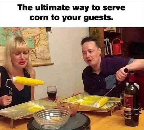 Two people eating corn on the cob spun on paint rollers, a strange corn serving idea